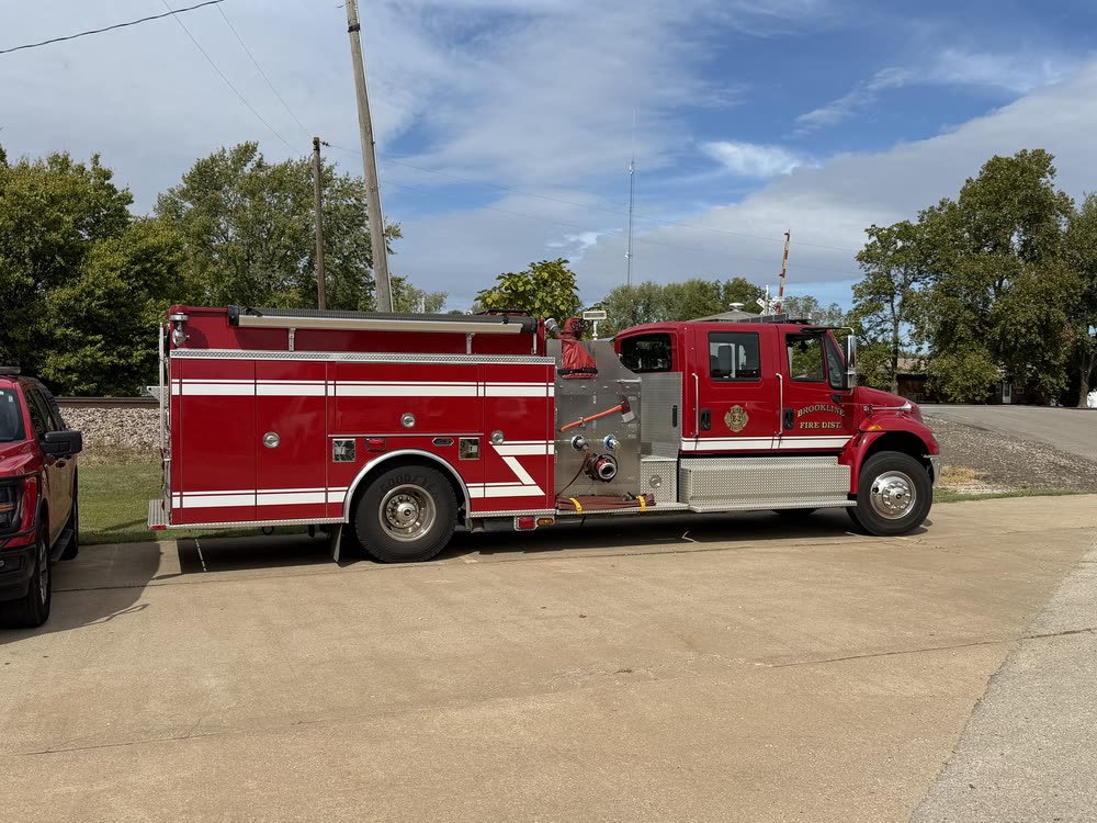 Engine 2, a red International crew-cab pumper, parked beside the station