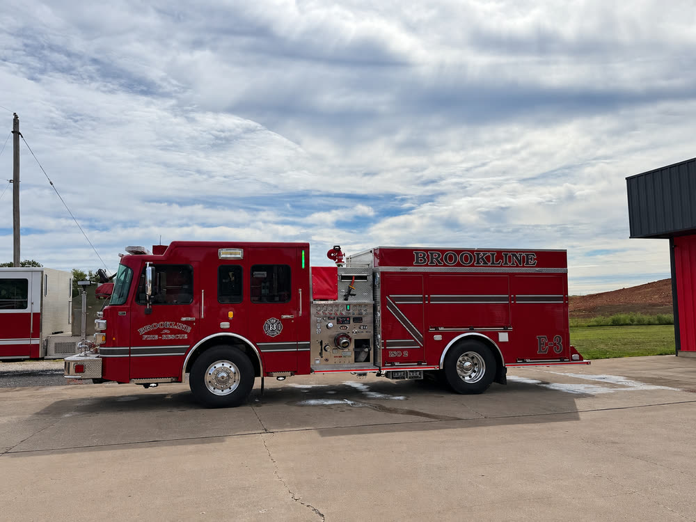 Engine 3, a red Ferrara pumper, parked on the apron outside the station